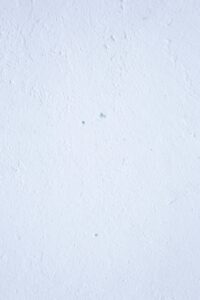 Image of a textured white wall with subtle imperfections, ideal for backgrounds.